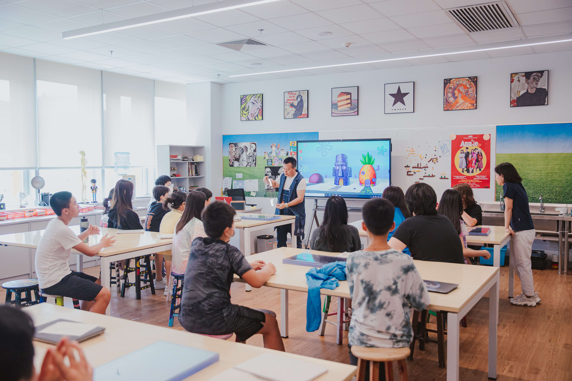 students sitting listening to artist talk in classroom