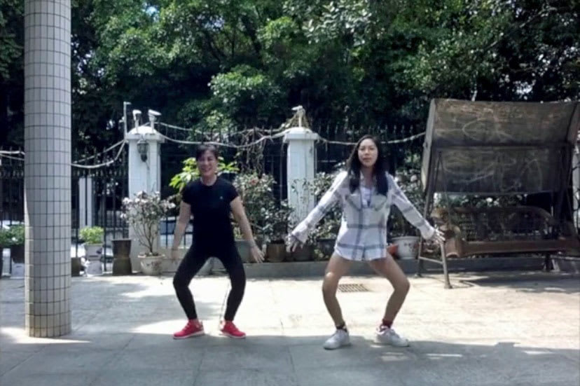 picture of a daughter and mom doing a dance together