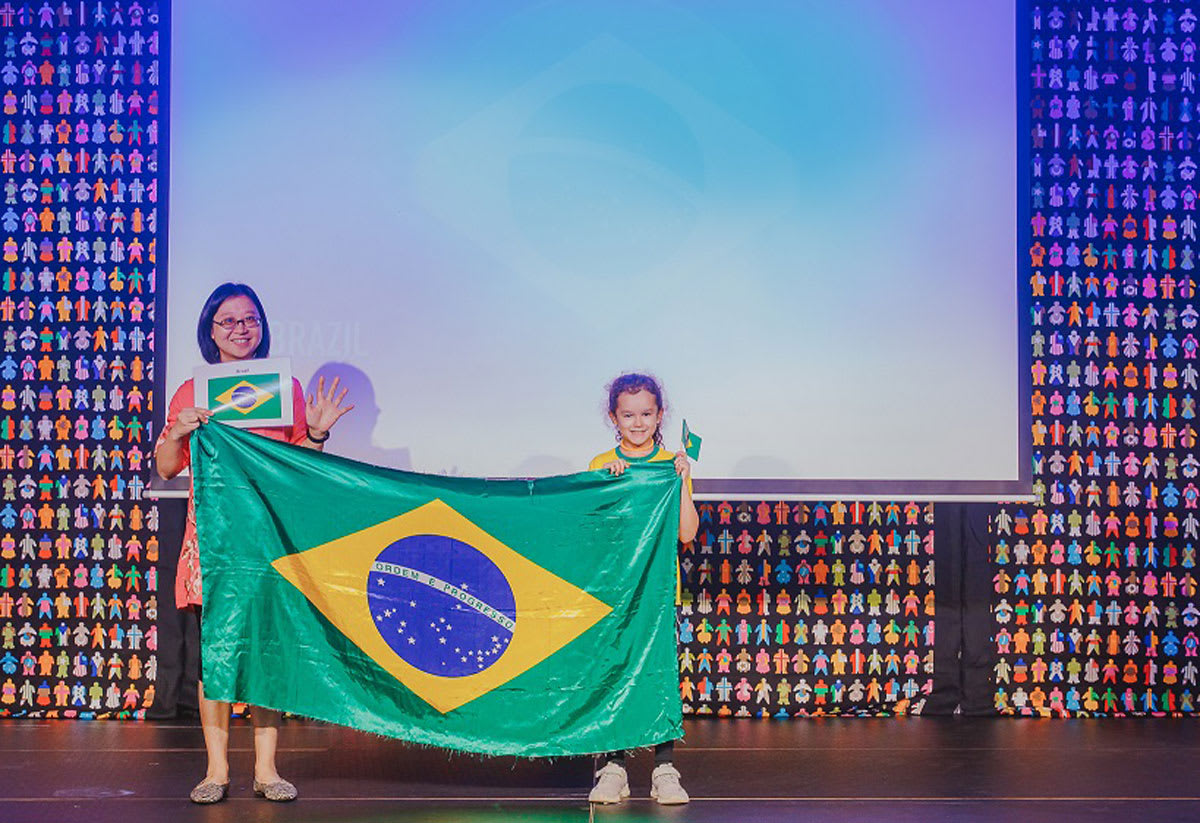 student holding the flag of Brazil