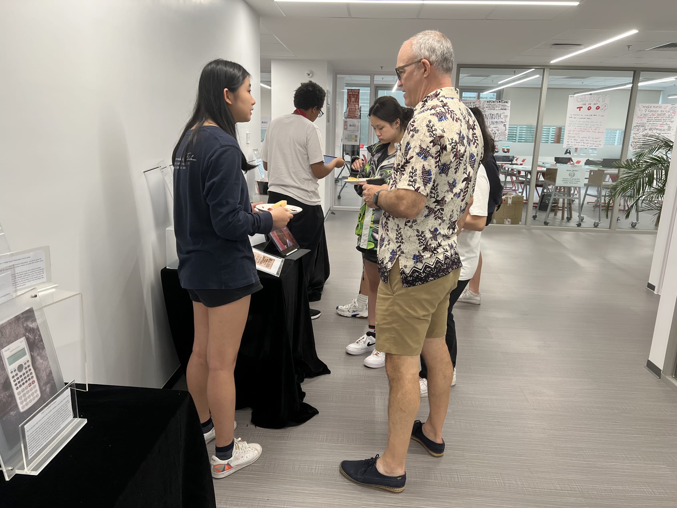 AISG TOK Exhibition with a student presenting her research to others