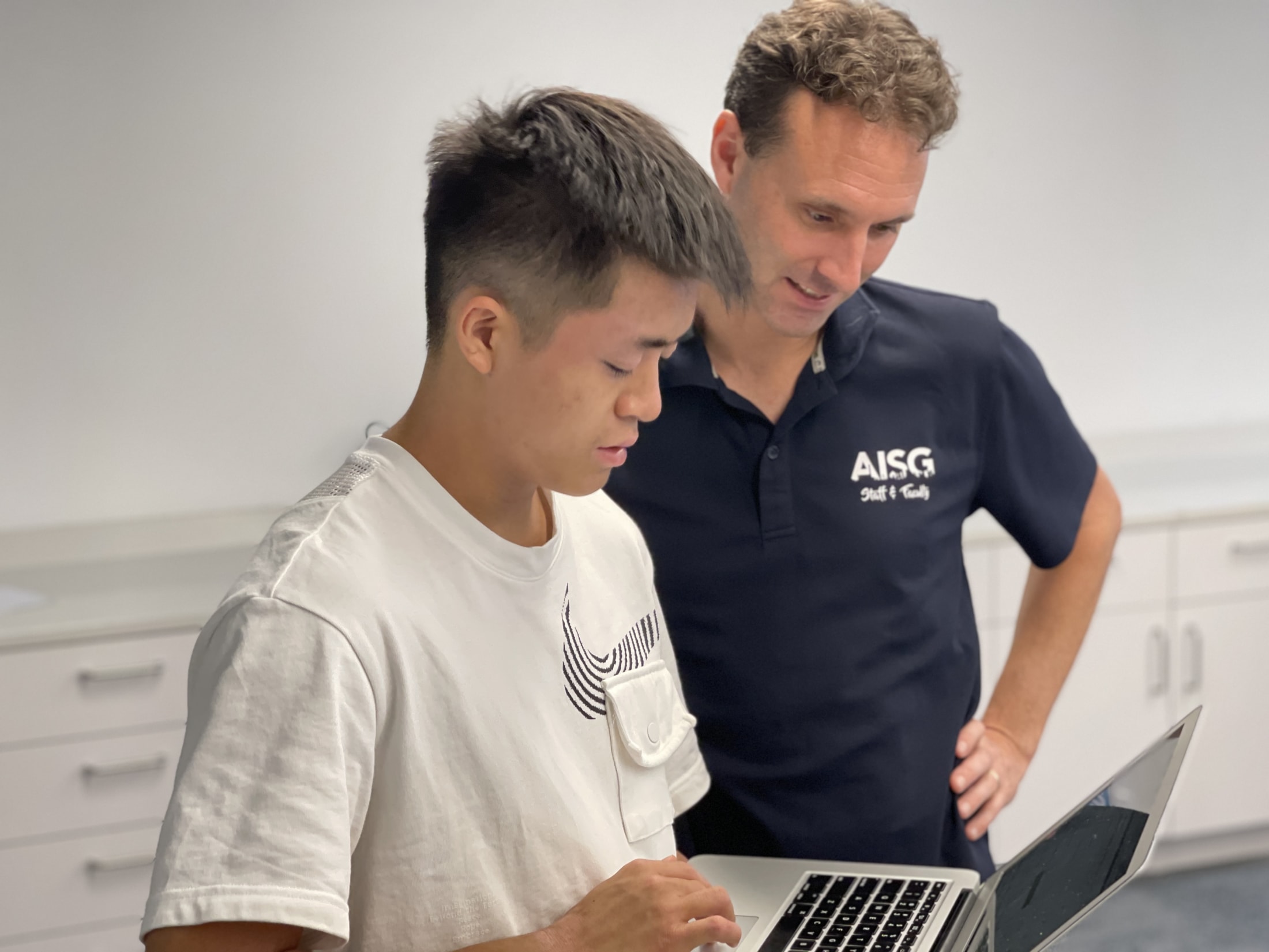 AISG College Counselor meeting with a male student 