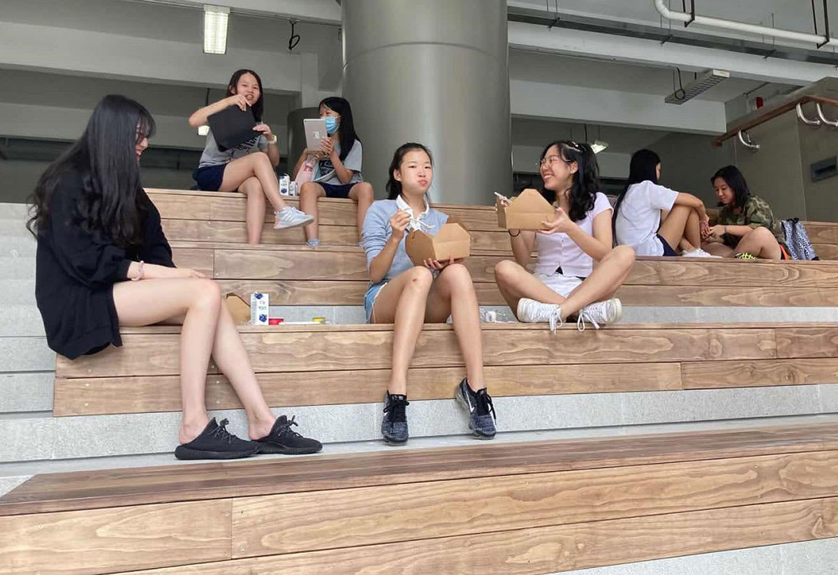 students eating lunch on the grand staircase in Science Park