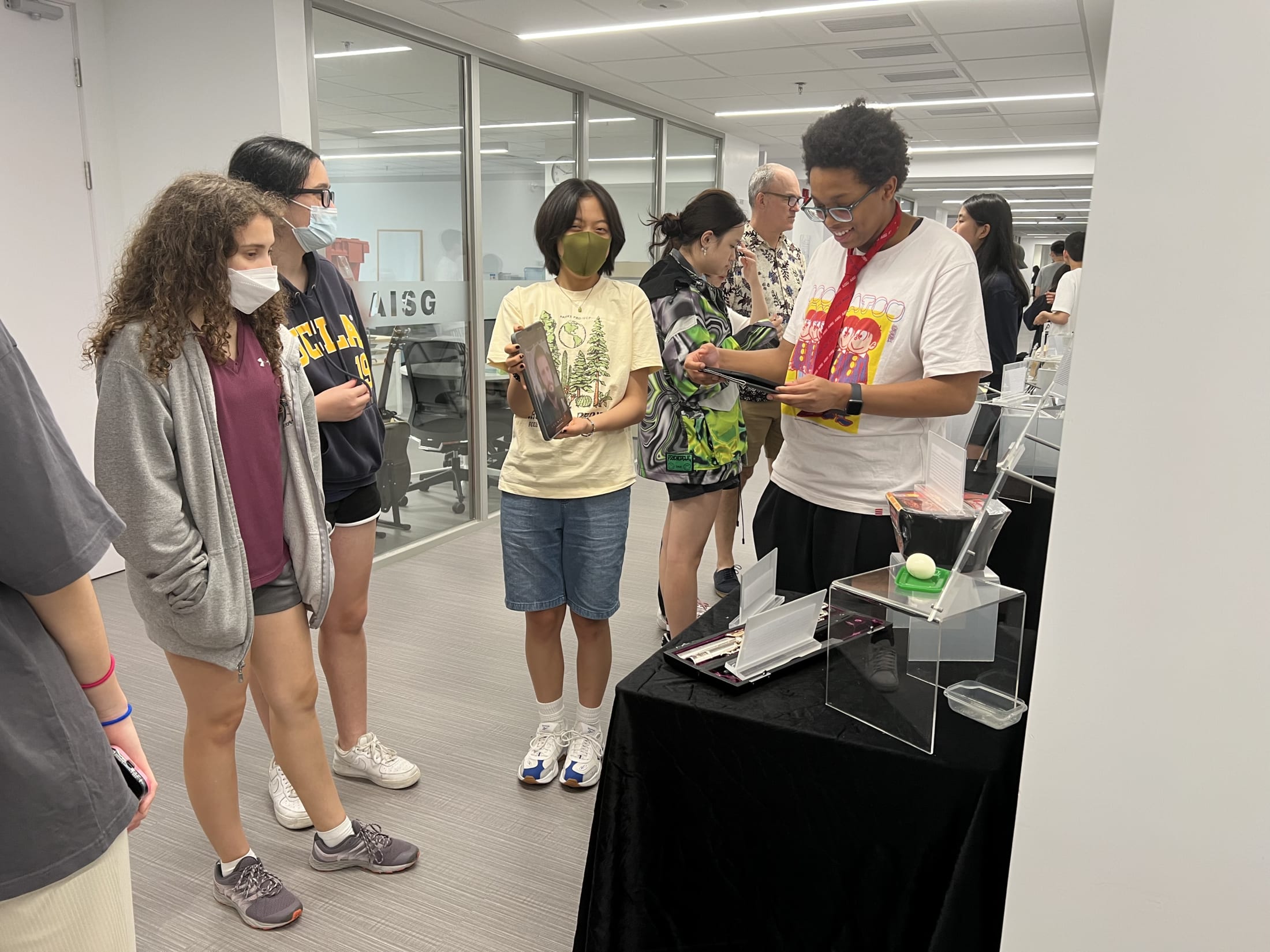 AISG TOK Exhibition with a student presenting her research to others