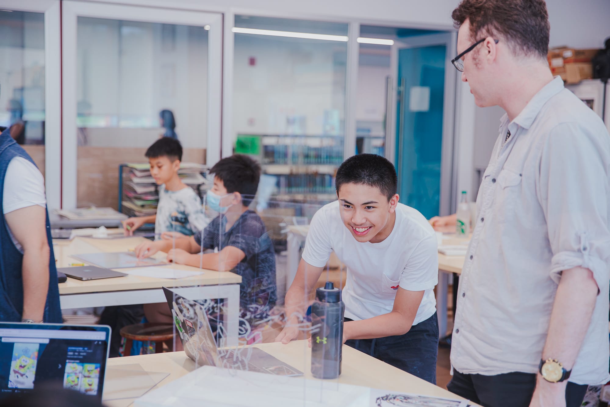student looking at painting through clear panels