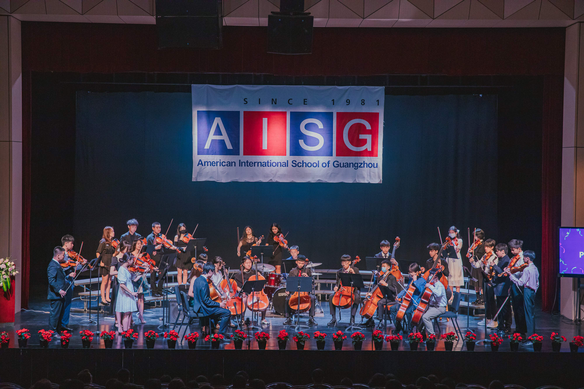 AISG Grade 8 Promotion orchestra playing onstage