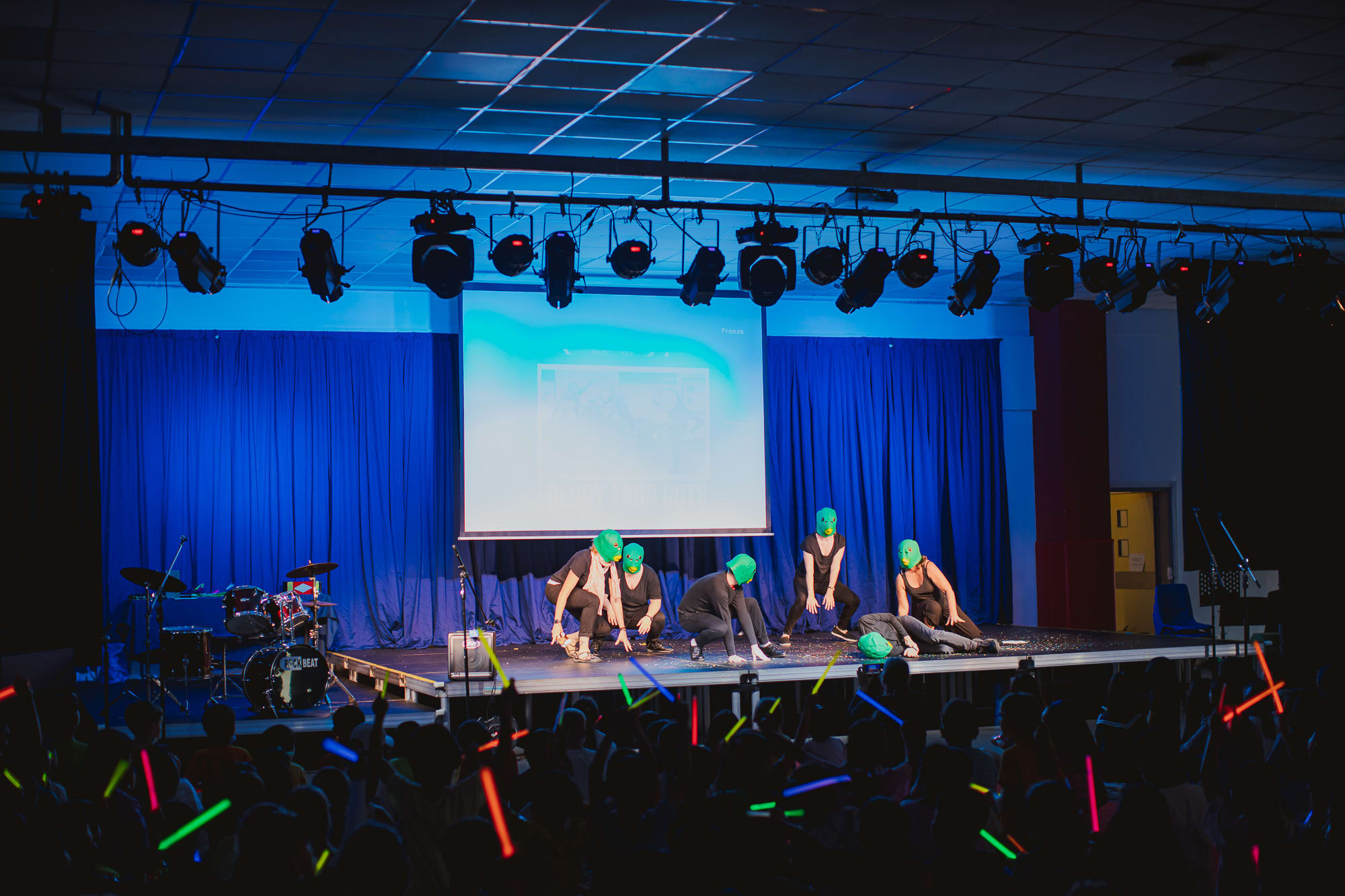 people in masks perform onstage