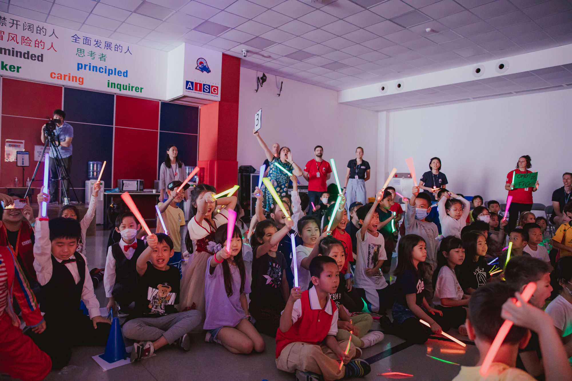 children waving glowsticks in a crowd