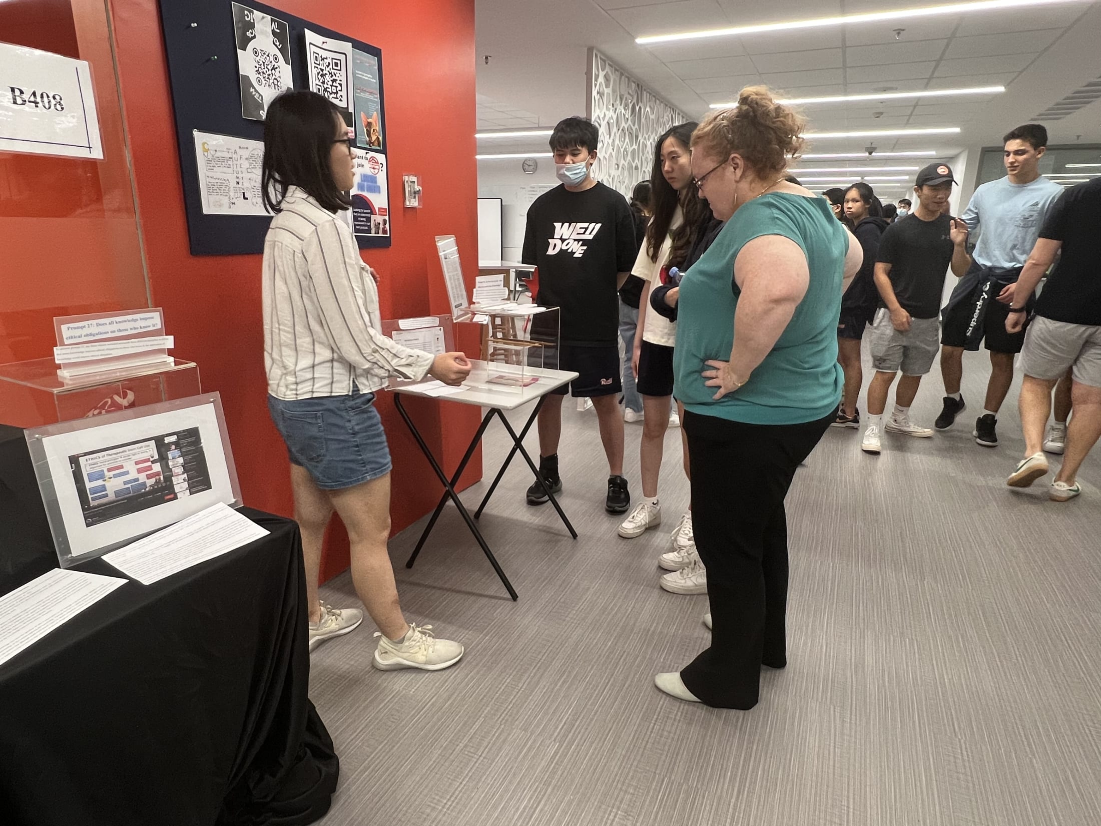 AISG TOK Exhibition with a student presenting her research to others