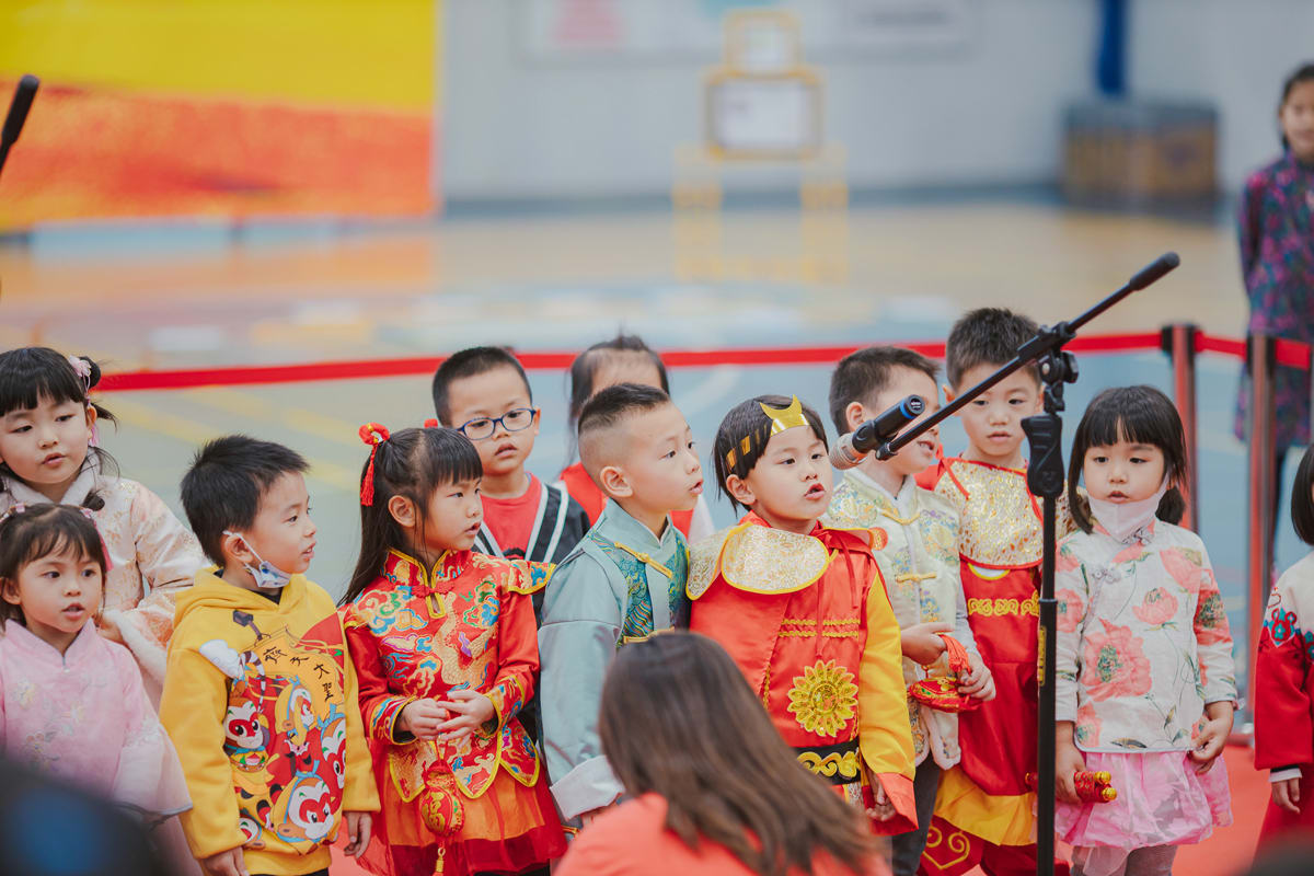 a young student sings into a microphone during the culture day celebration