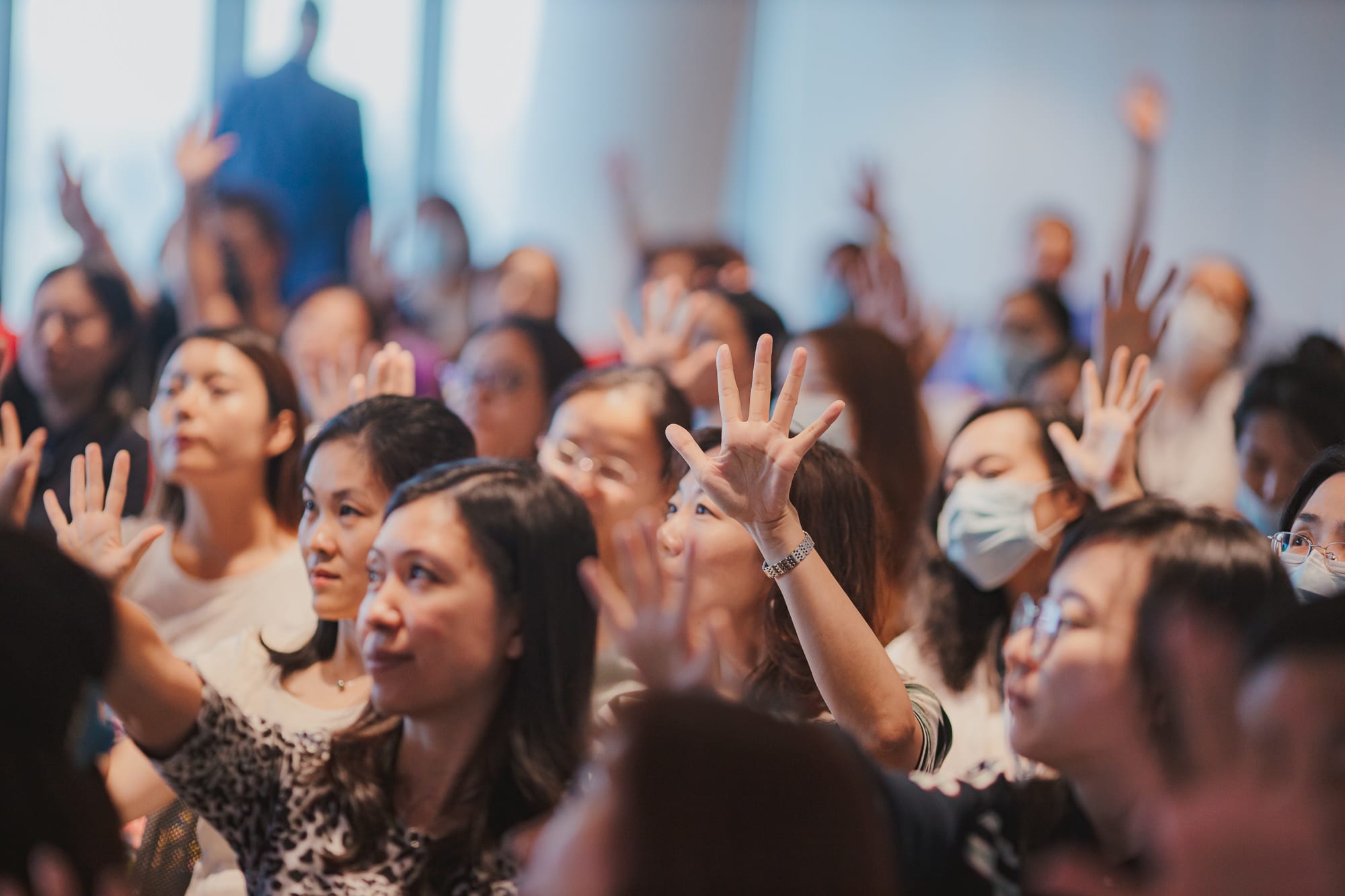 crowd of women raising their hands
