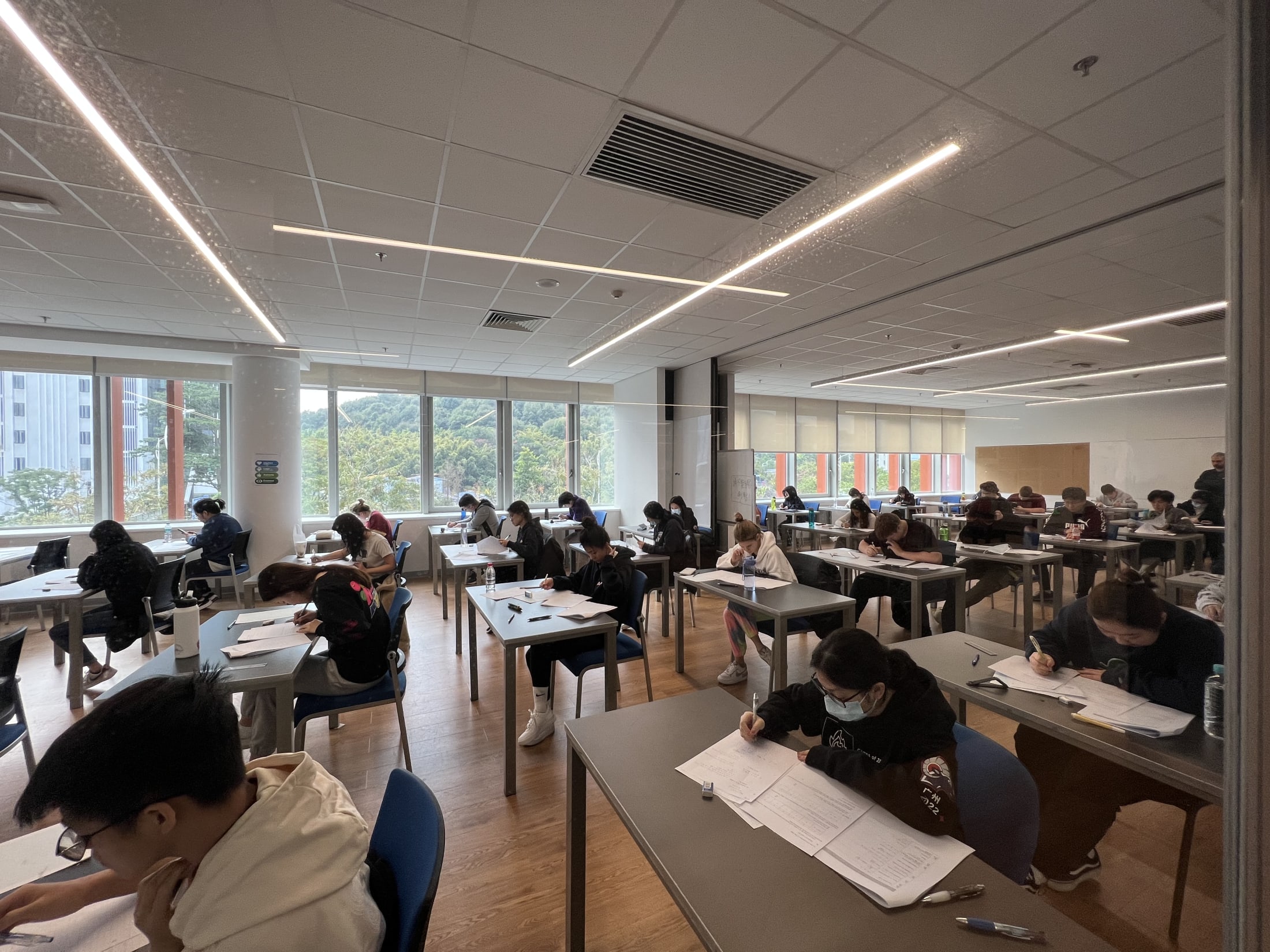 AISG students taking a mock IB exam in AISG classroom (side view)
