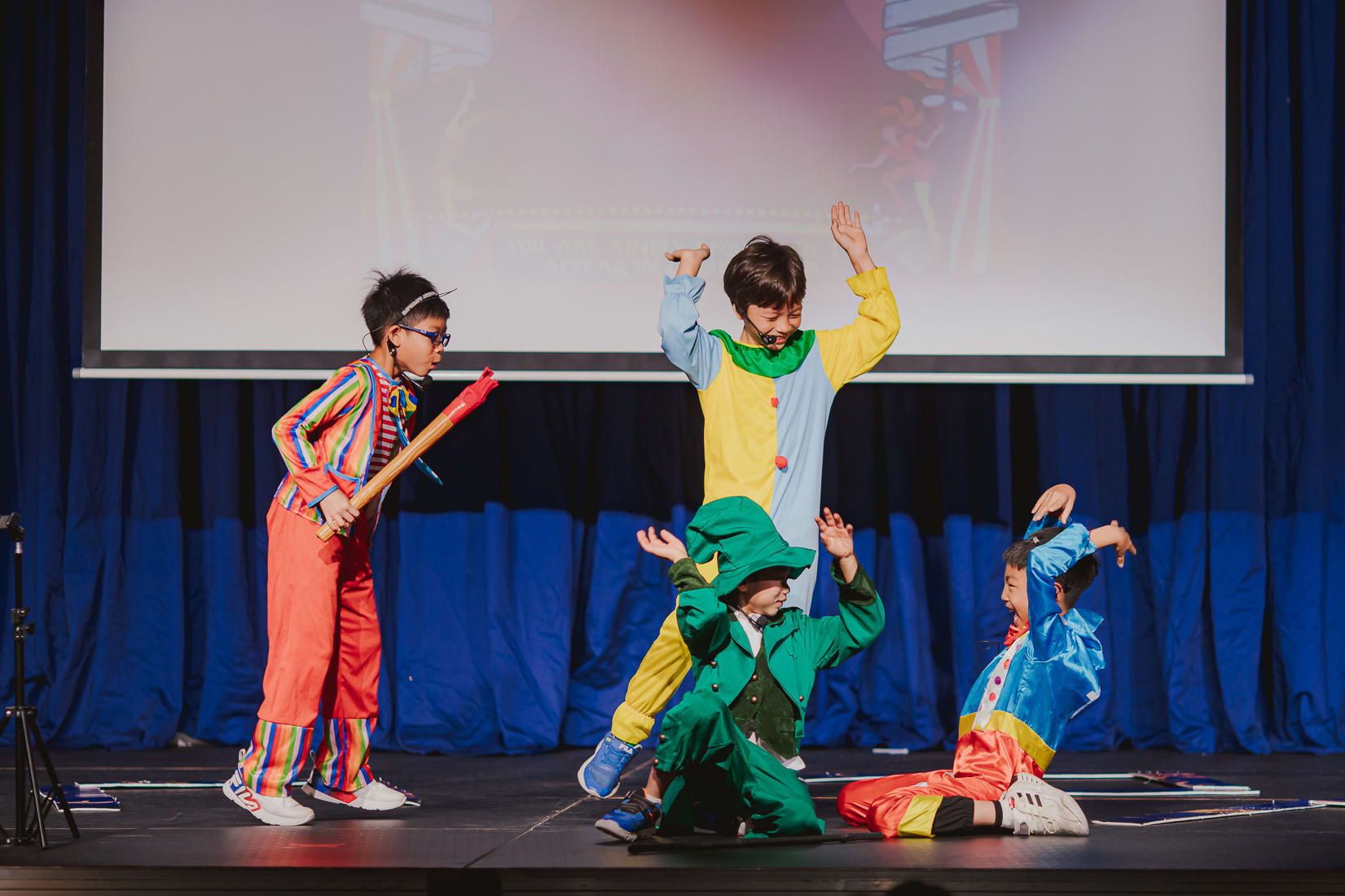 children in circus outfits onstage performing