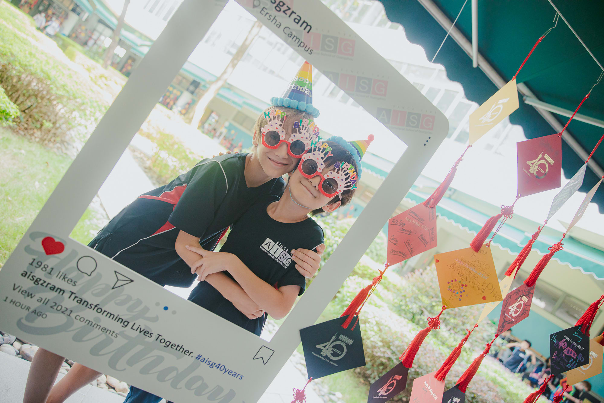 AISG's 40th birthday celebration with elementary students taking photos in instagram booths at Ersha