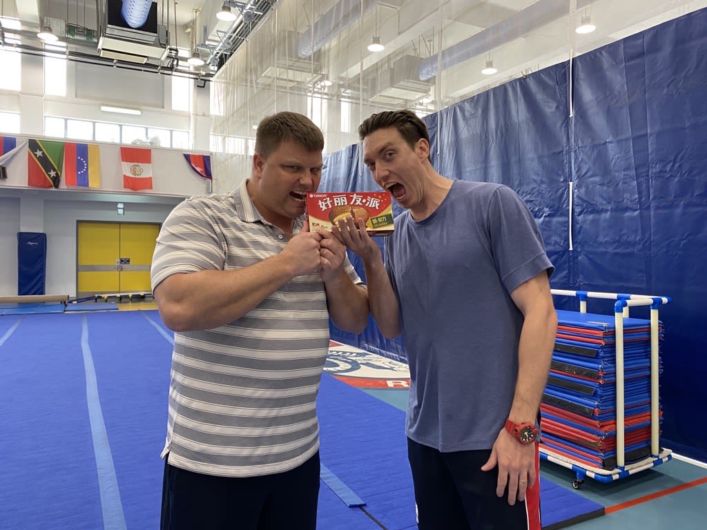 AISG celebrates Teacher Appreciation Week with two faculty taking a big bite of box of sweets