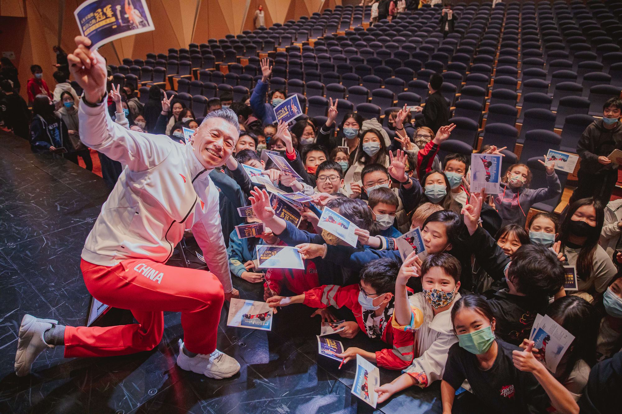 AISG Speaker Series with Hou Bin and students holding his flyer