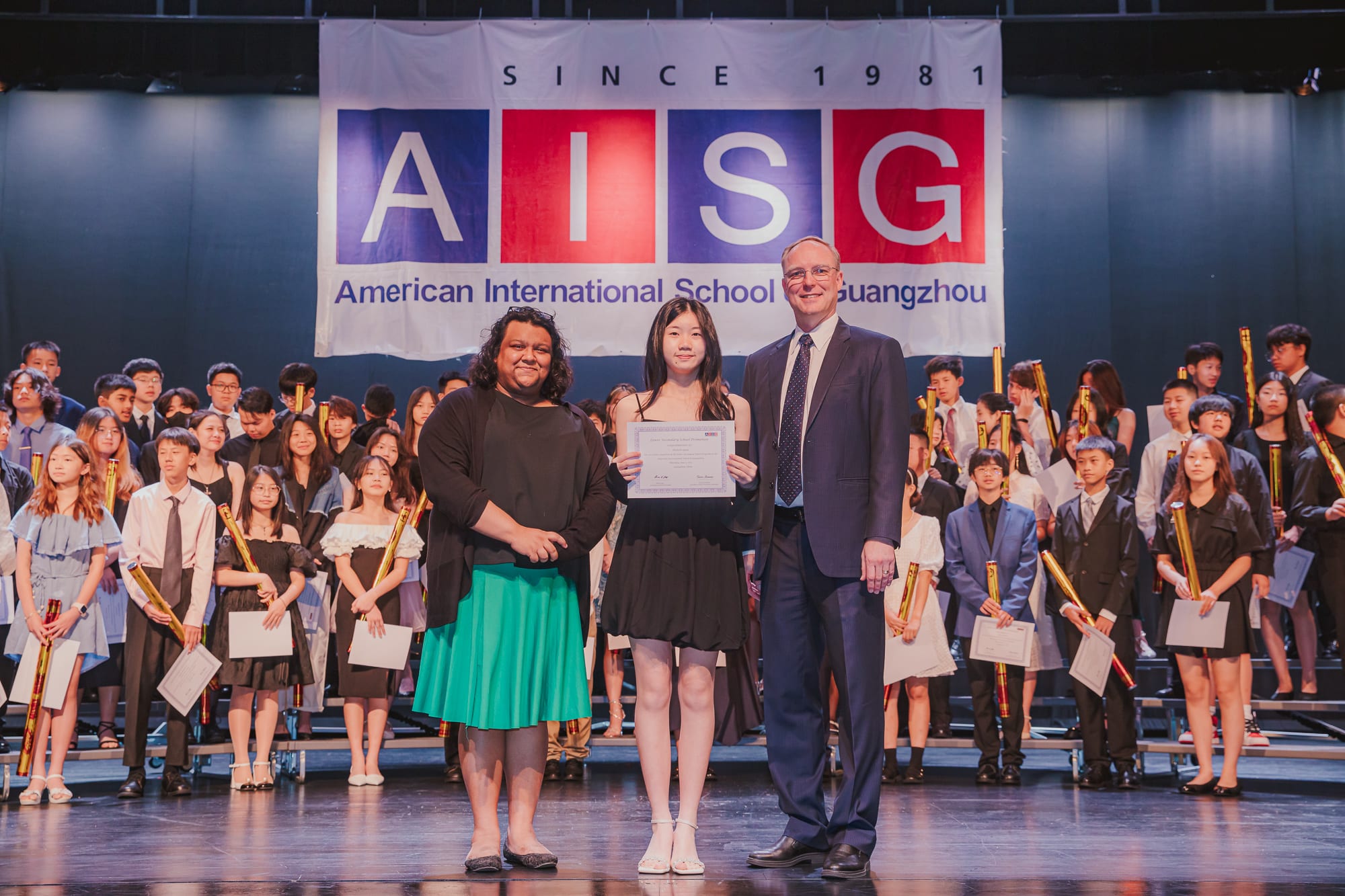AISG Grade 8 Promotion student receiving certificate from principals
