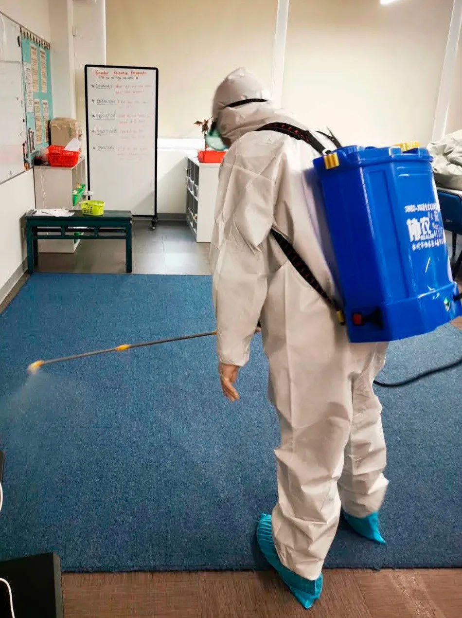 picture of a person disinfecting classrooms