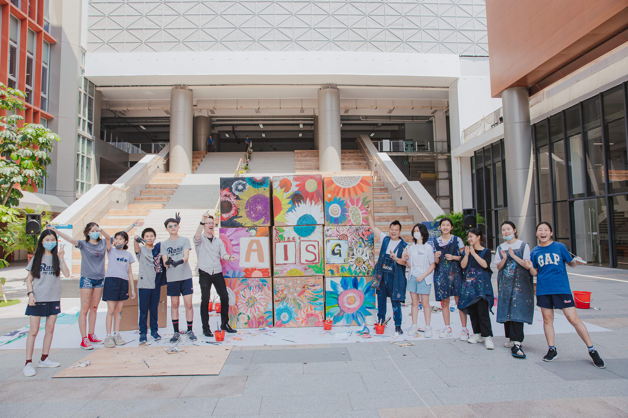 students posing with painted cardboard boxes