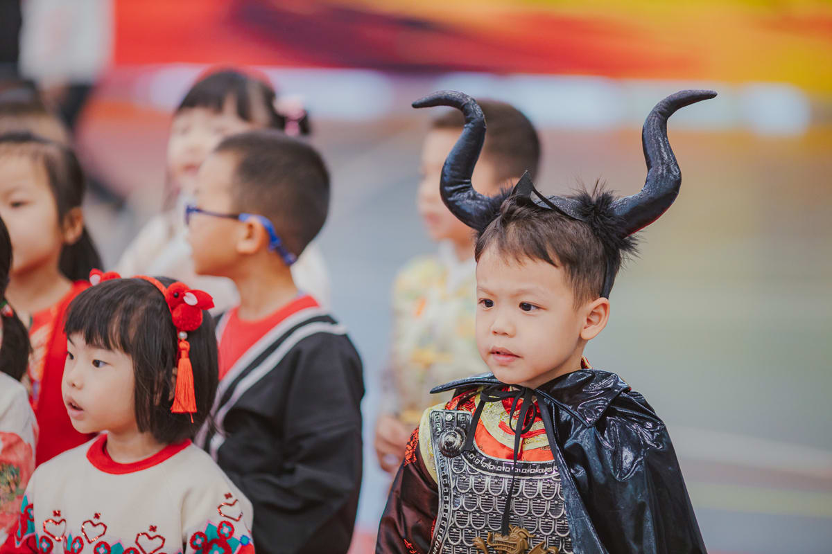 a boy is wearing a with ox horns on it during the culture day celebration