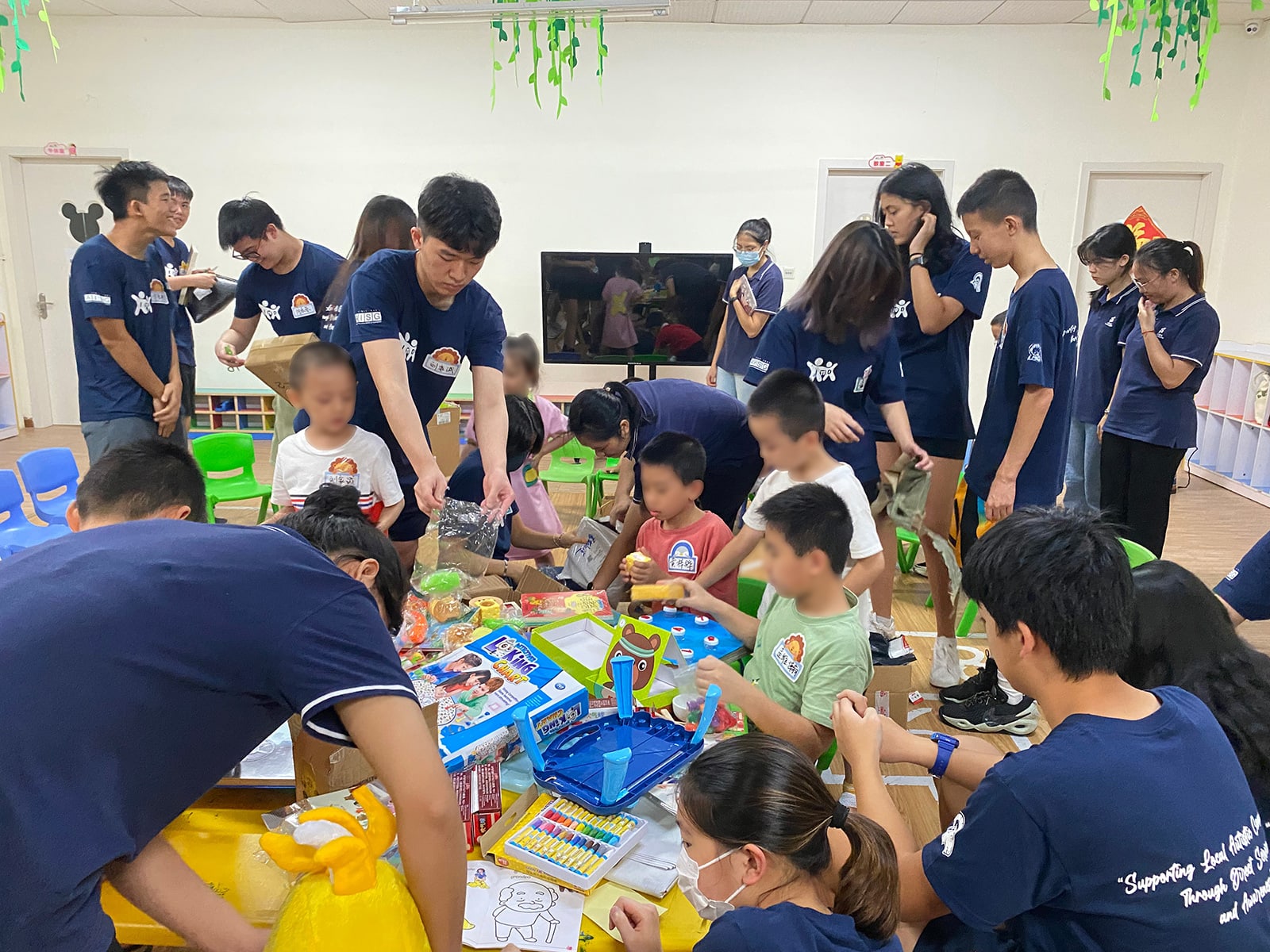 AISG students play toys with autistic community kids