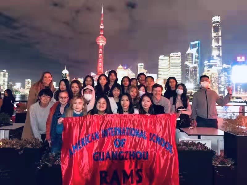 AISG at APAC in Shanghai with group shot of AISG students and Shanghai skyline in background