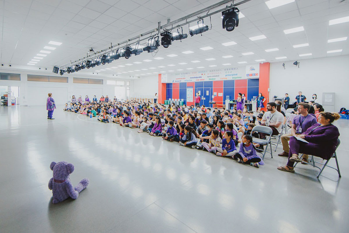 gymnasium filled with children listening to a program on how to stay safe