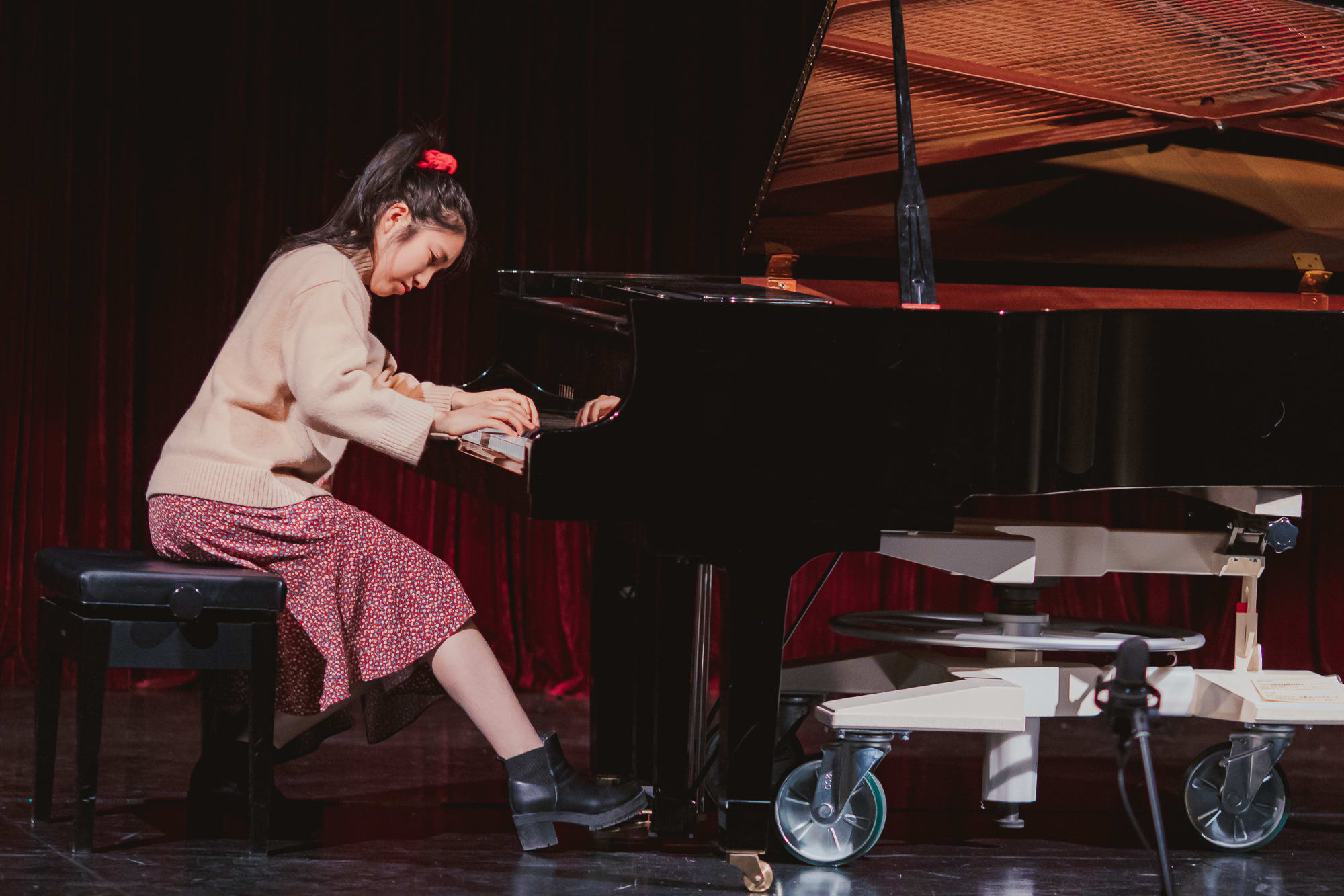An AISG senior student playing the piano for the International Baccalaureate (IB) Music Recital