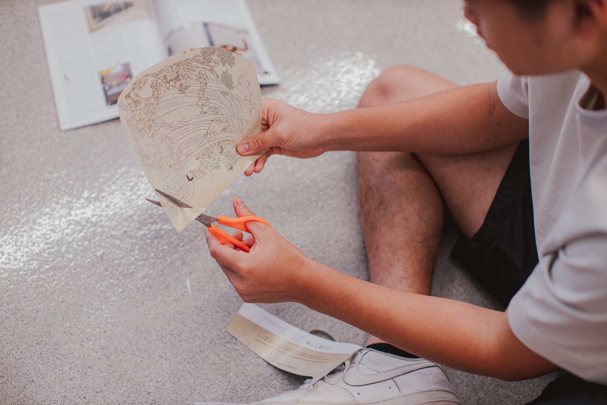 student cutting paper