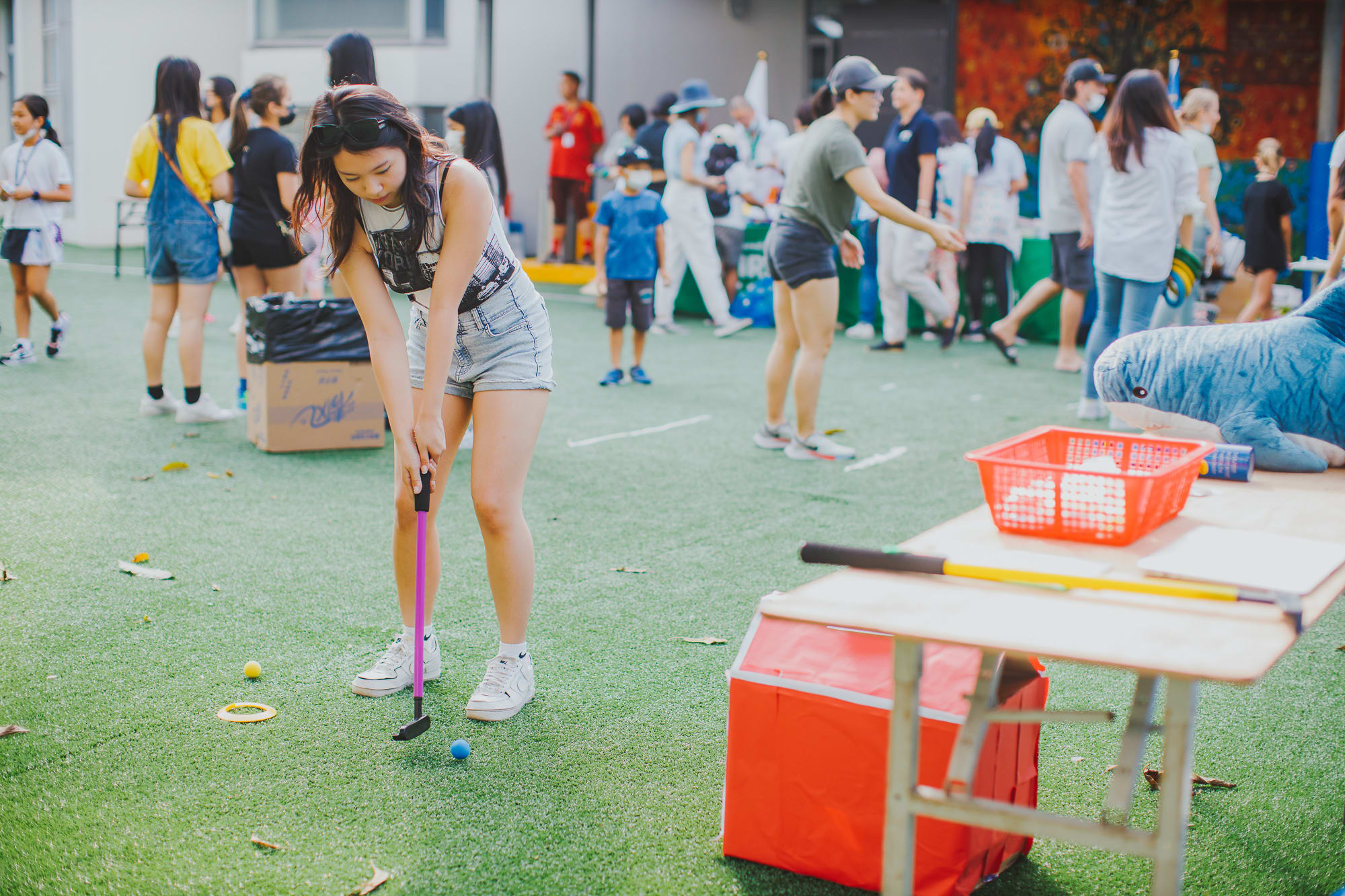AISG Family Fun Day for SY2122 with a student playing mini golf