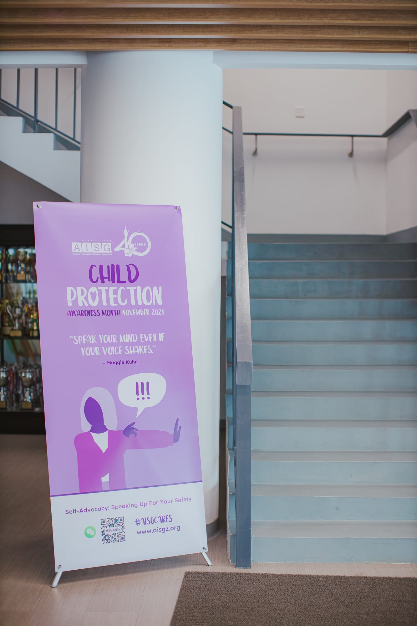 A child protection banner along the stairways for AISG Child Protection Awareness Month