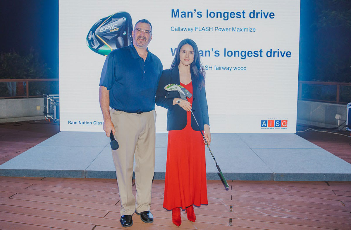 kevin baker gives congratulations to the women's longest drive winner