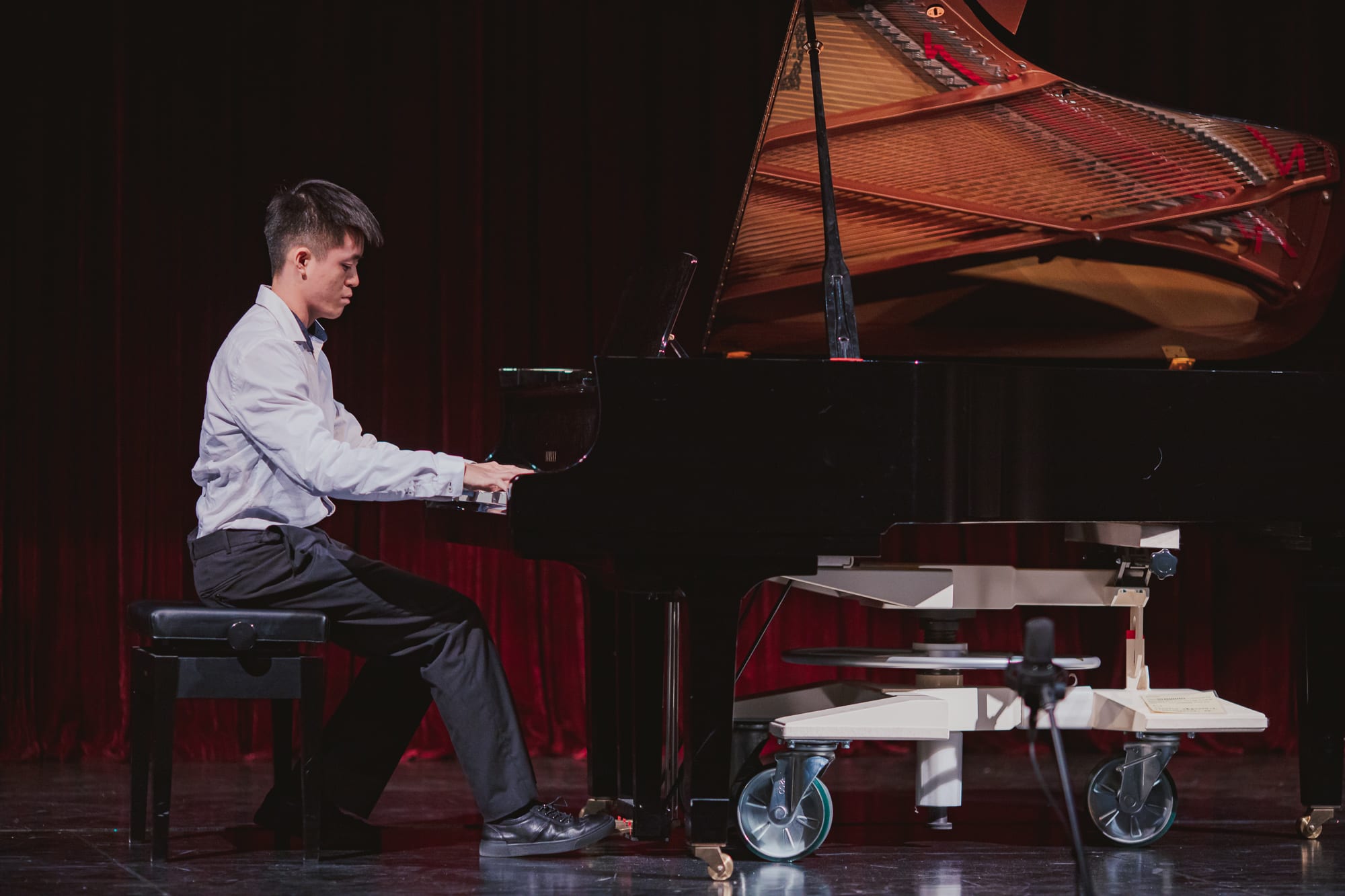 An AISG senior student playing the piano for the International Baccalaureate (IB) Music Recital