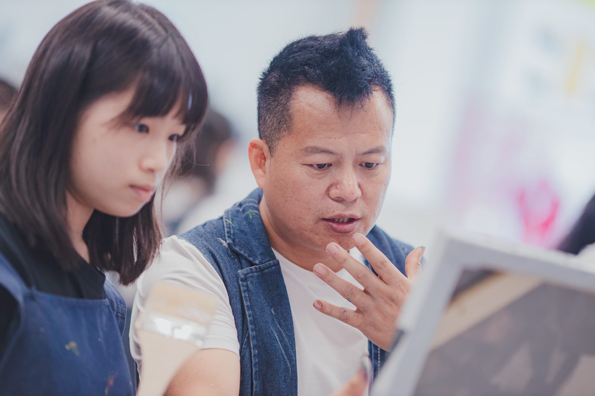 artist explaining something to student