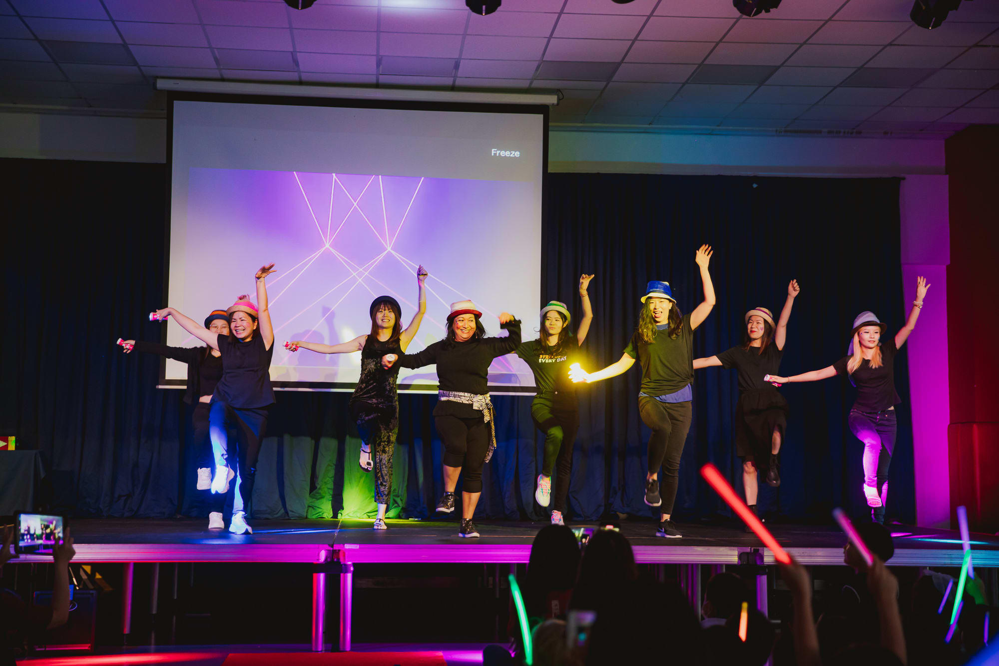 people on stage dancing in a row