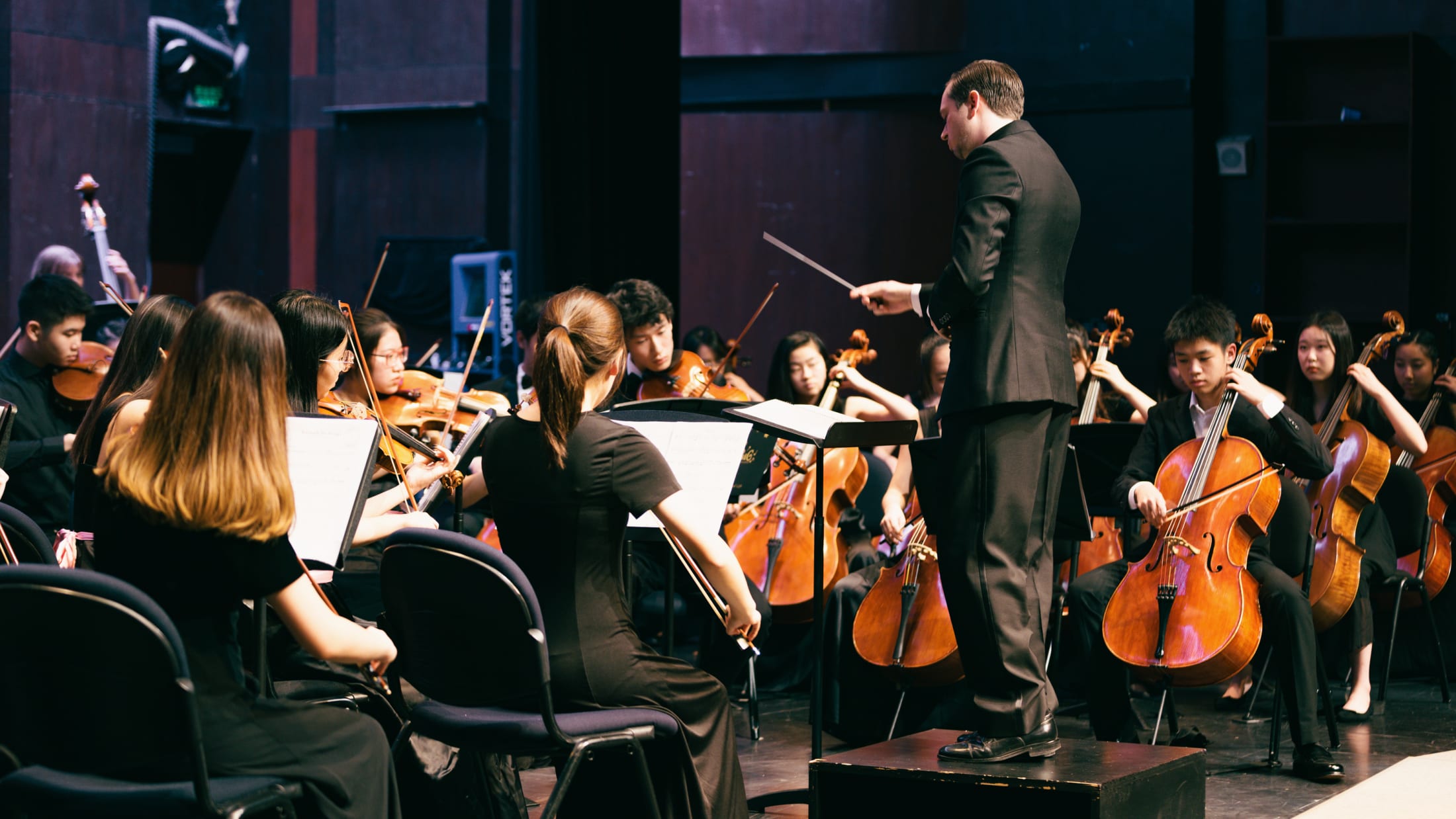 AISG at APAC in Shanghai with string orchestra students and conductor