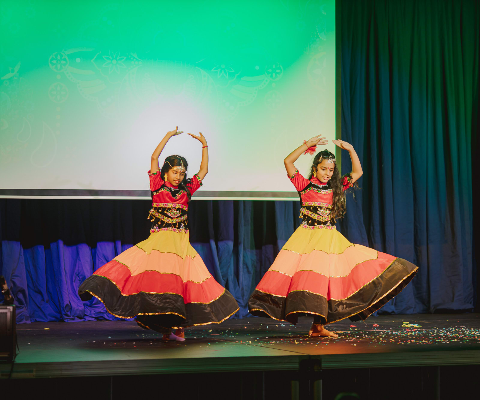 two girls in traditional outfits dancing