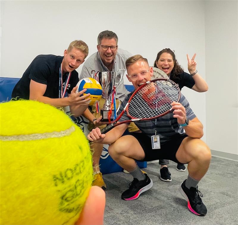 AISG new faculty holding sports equipment