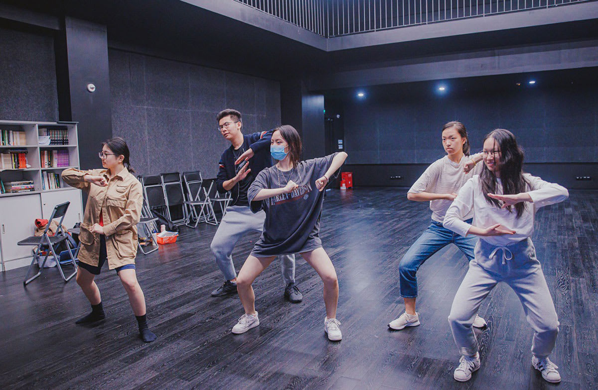 IB theater students dancing in a performance