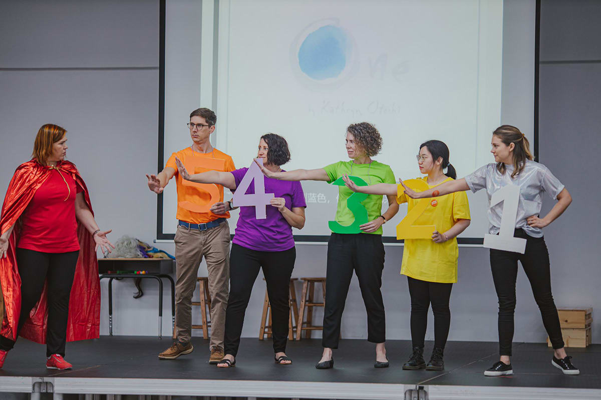 Teachers playing on the stage in front of students