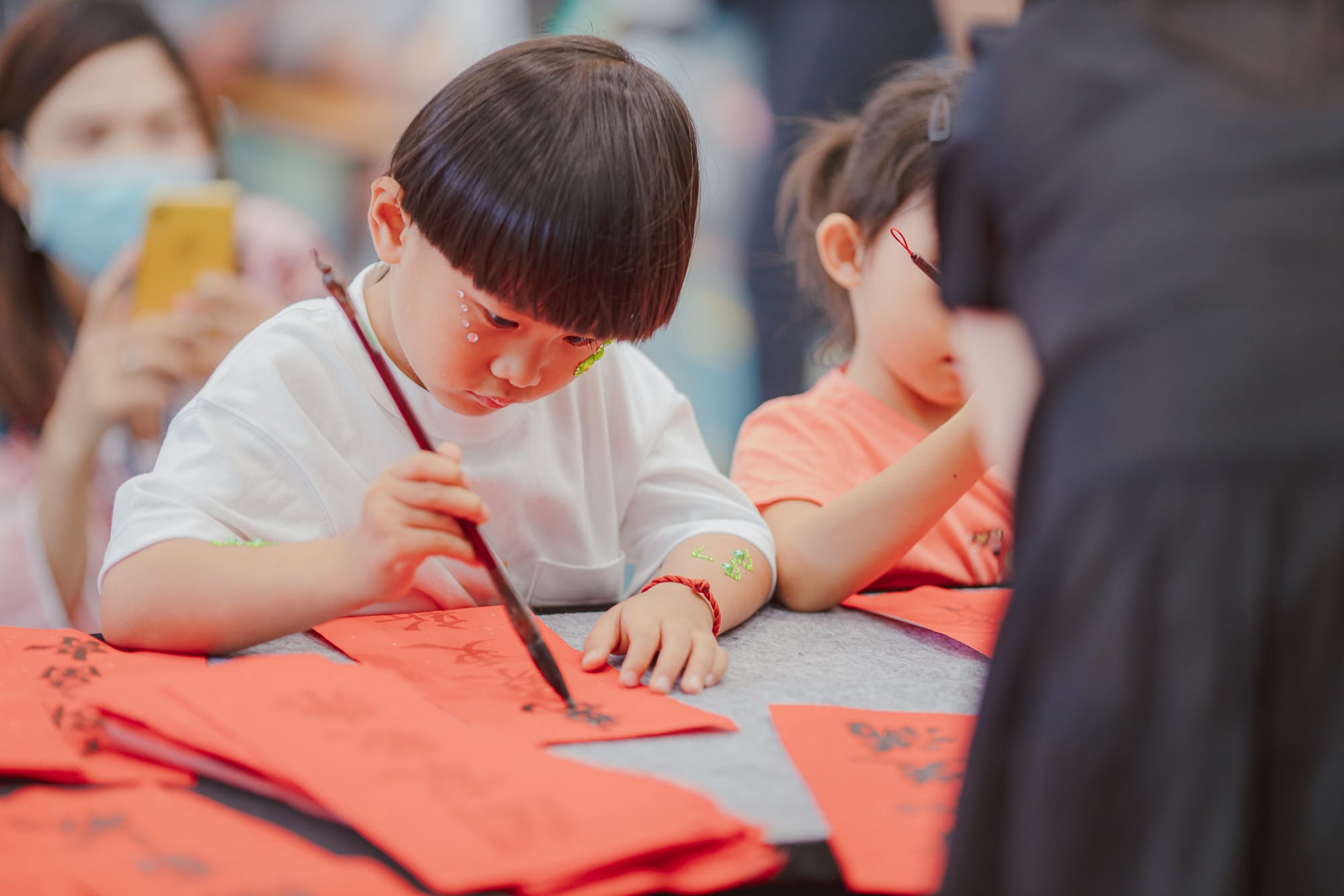 child doing calligraphy