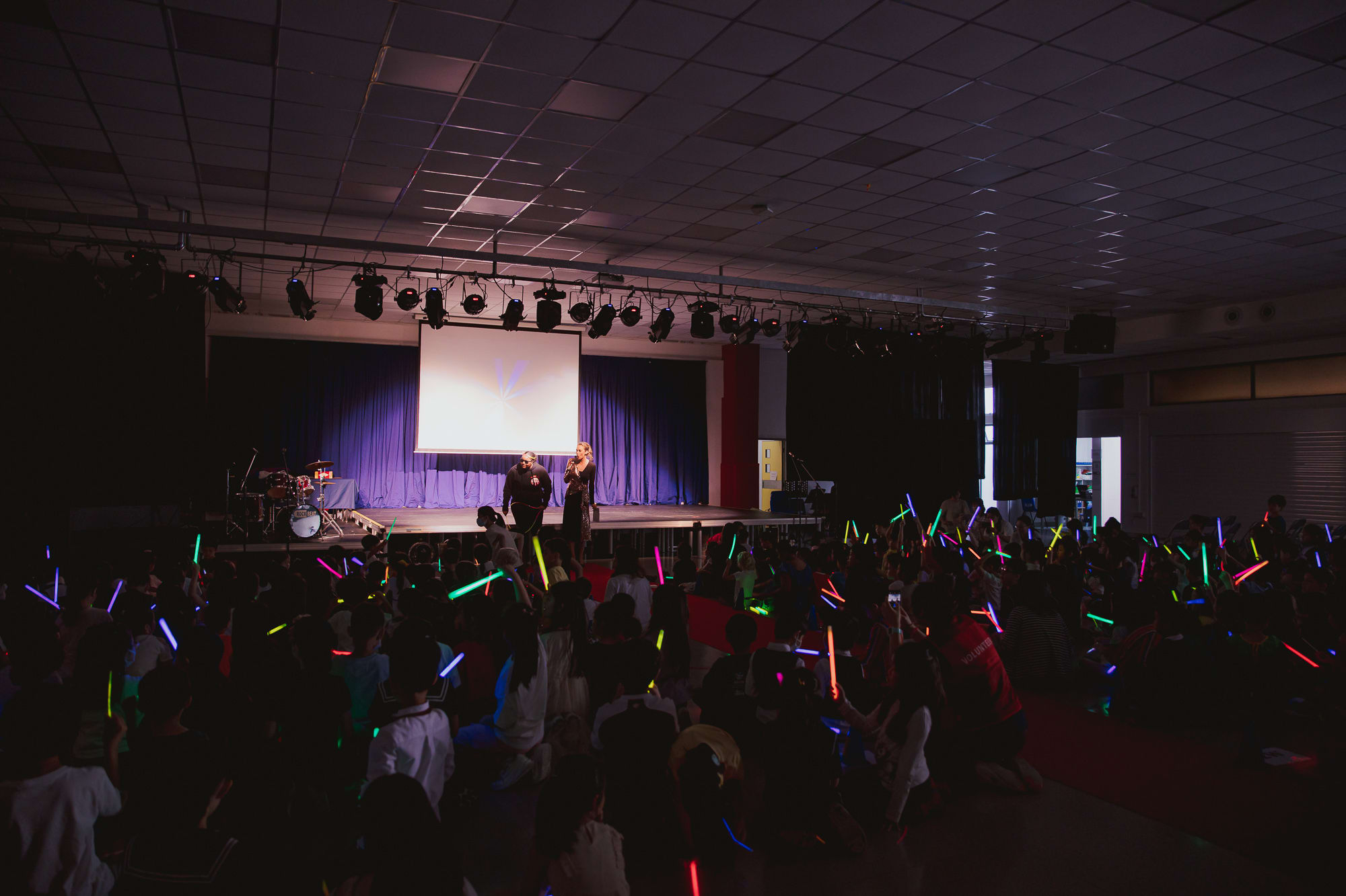 two people hosting a show with a crowd