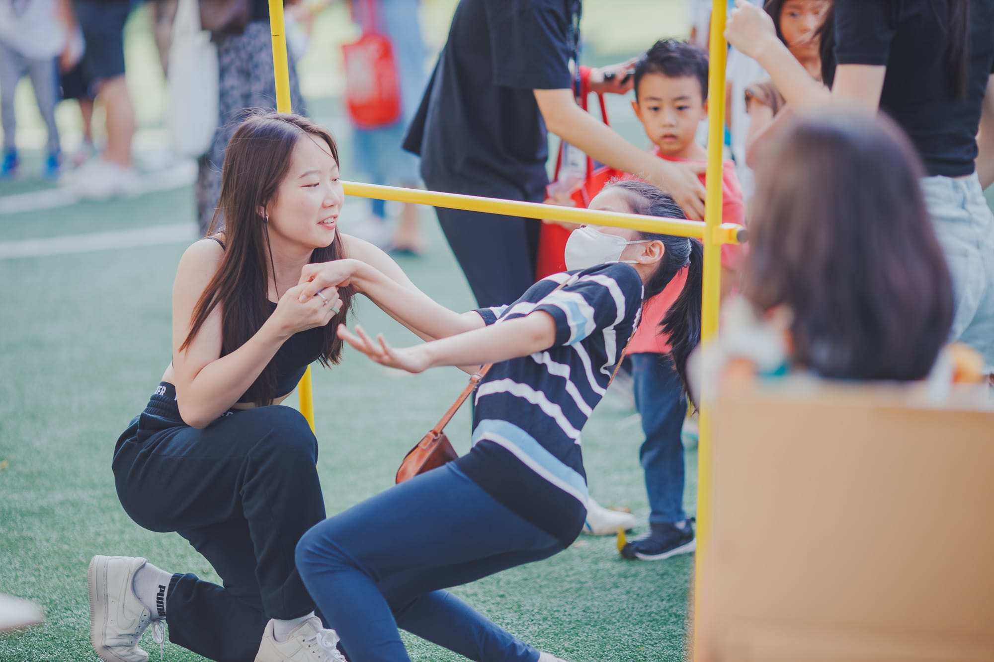 AISG Family Fun Day for SY2122 with elementary students playing limbo