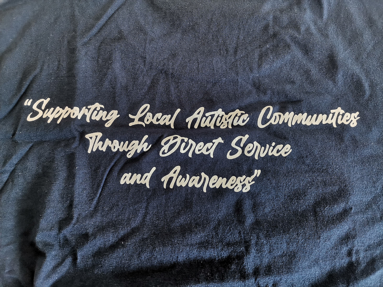 AISG students supporting local autistic communities t-shirt slogan