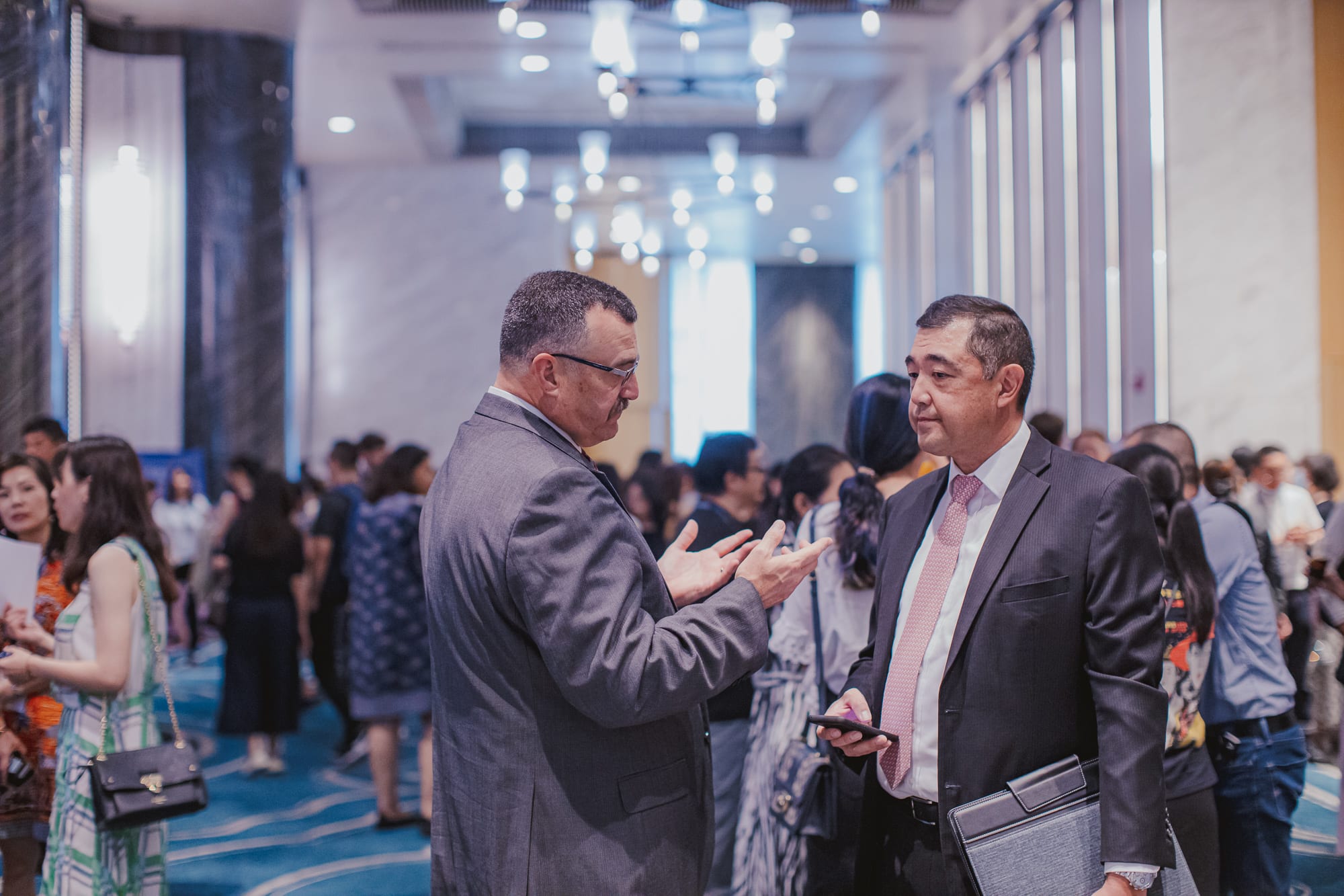 two men in suits talking