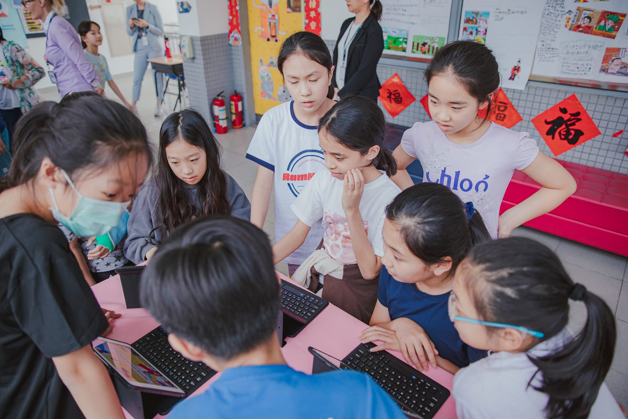 AISG PYP Exhibition with students gathered around a project