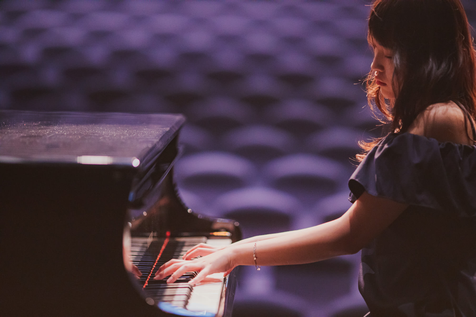 An AISG senior student playing the piano for the International Baccalaureate (IB) Music Recital