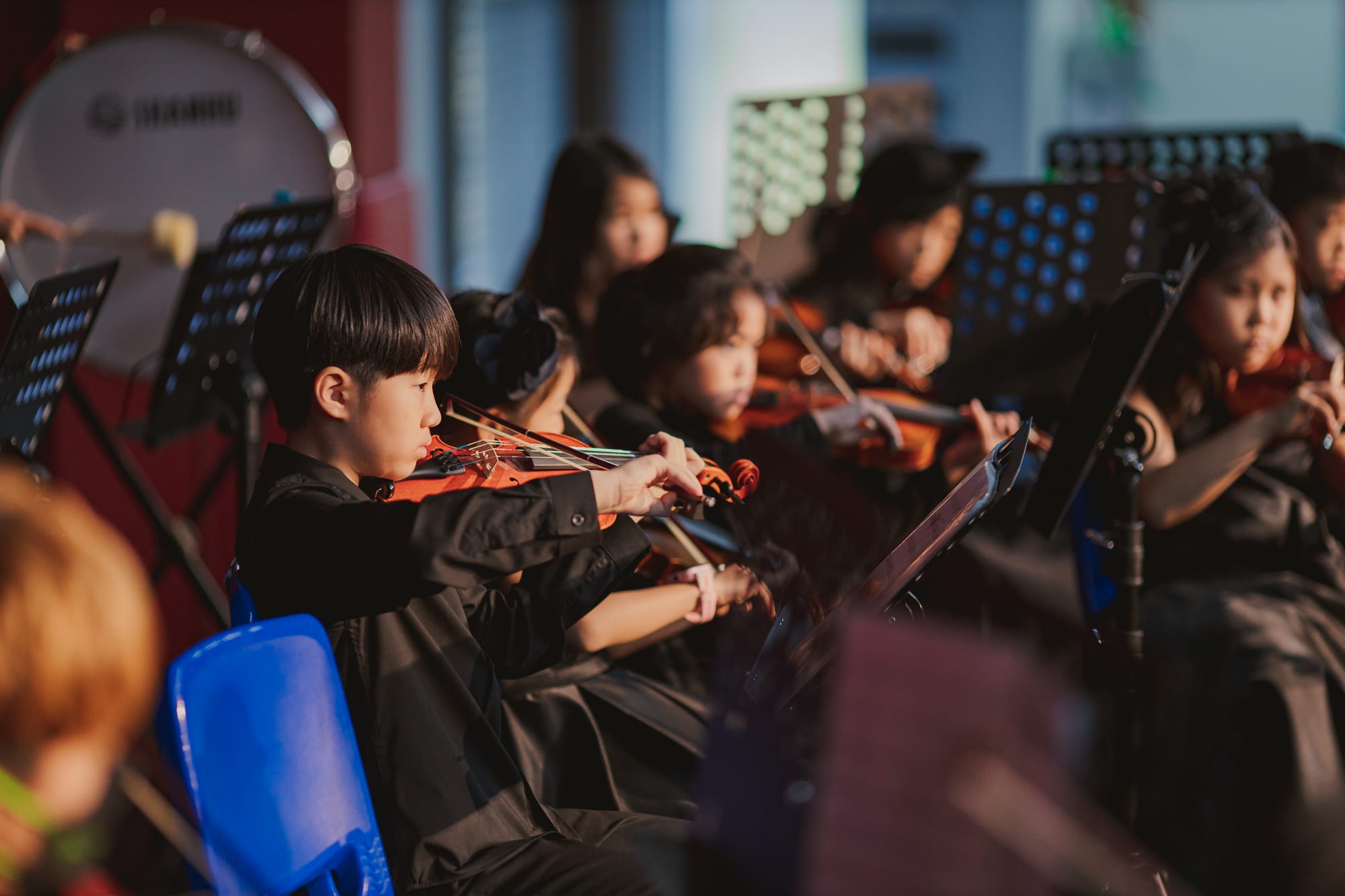 AISG elementary school students playing instruments in a performance
