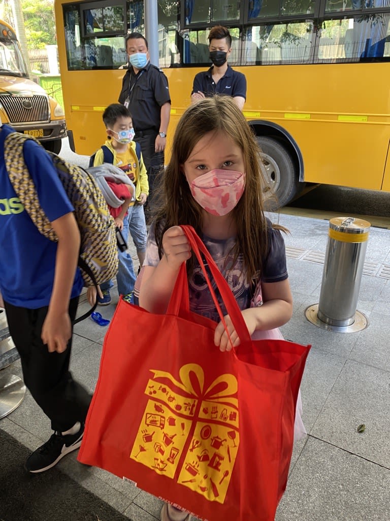 AISG celebrates Teacher Appreciation Week with a student giving a bag of gifts