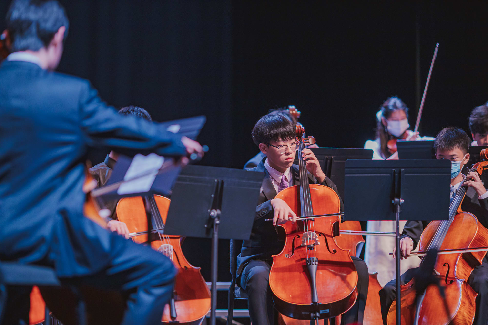 AISG Grade 8 Promotion student playing cello in ensemble
