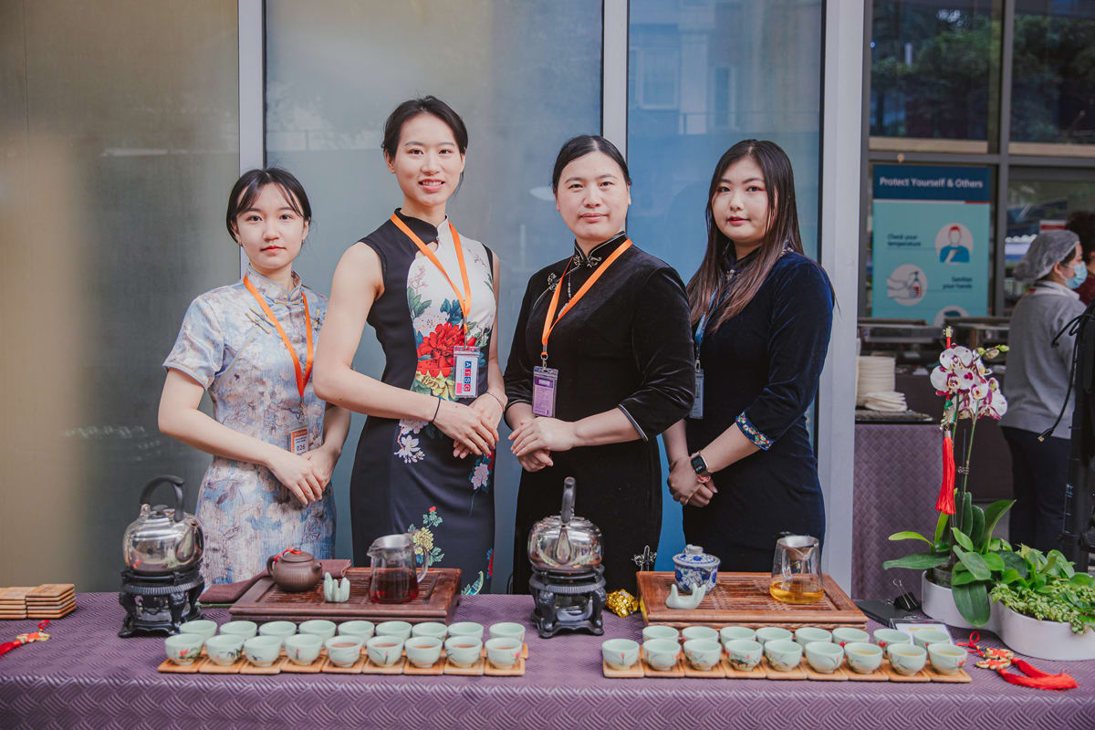four women posting with their servings of tea at the hongbao celebration